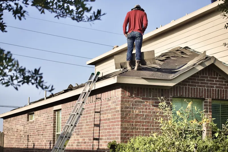 Professional roofer working on a residential roof in Plaza Terrace